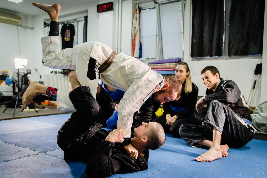Brazilian Jiu JItsu BJJ professor teaching technique from the guard position